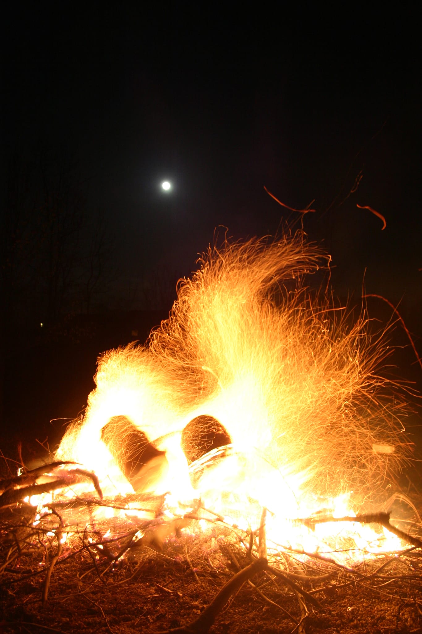 Raging bonfire with moon