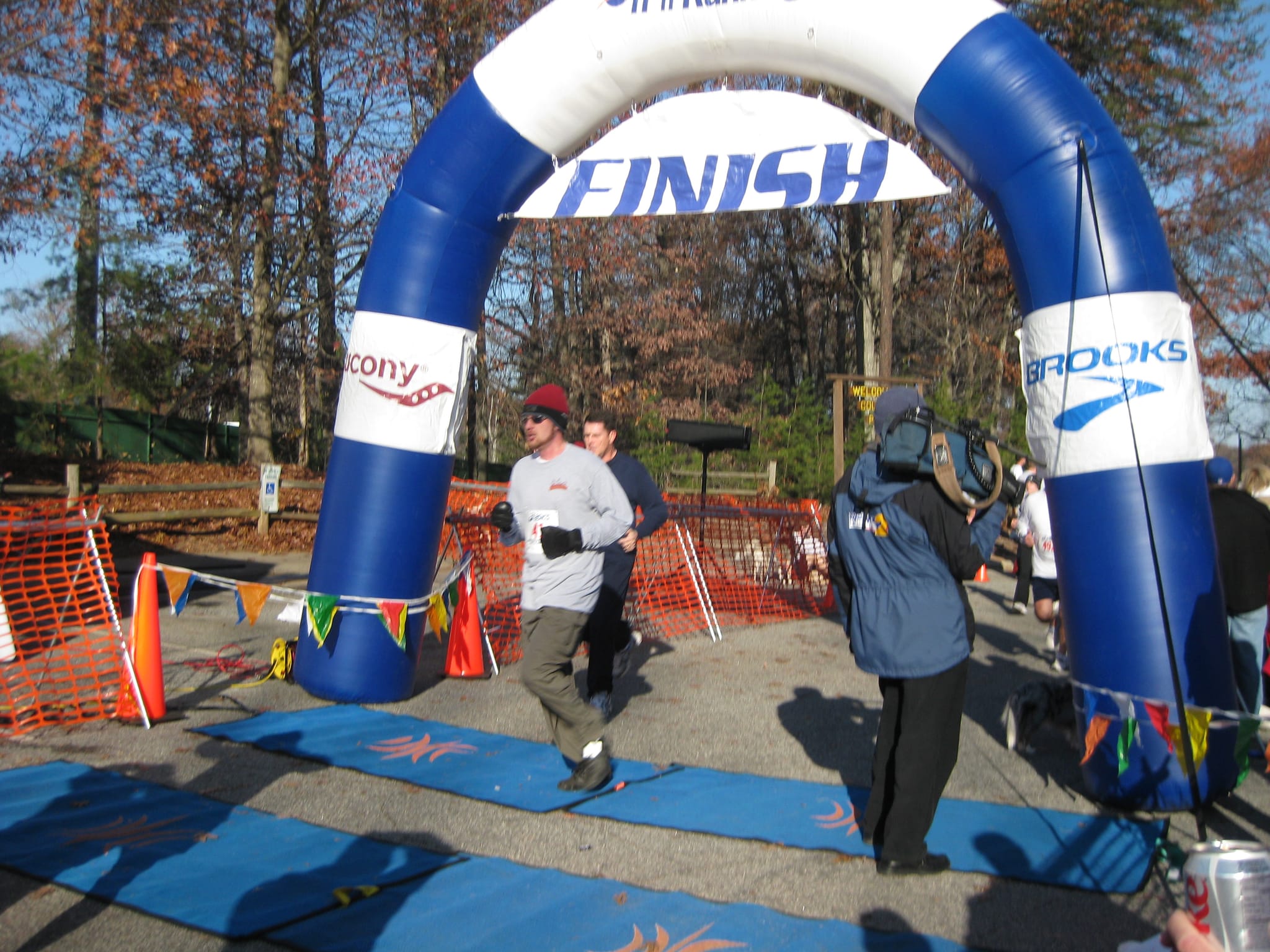Chris crossing the finsh line at the Greensboro Gobbler 5K