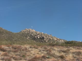 Moon over rocky terrain