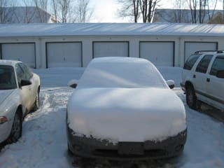 front of snowy car