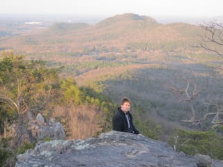 Chris on top of King's Pinnacle in Crowder Mountain State Park, NC - with crazy hair