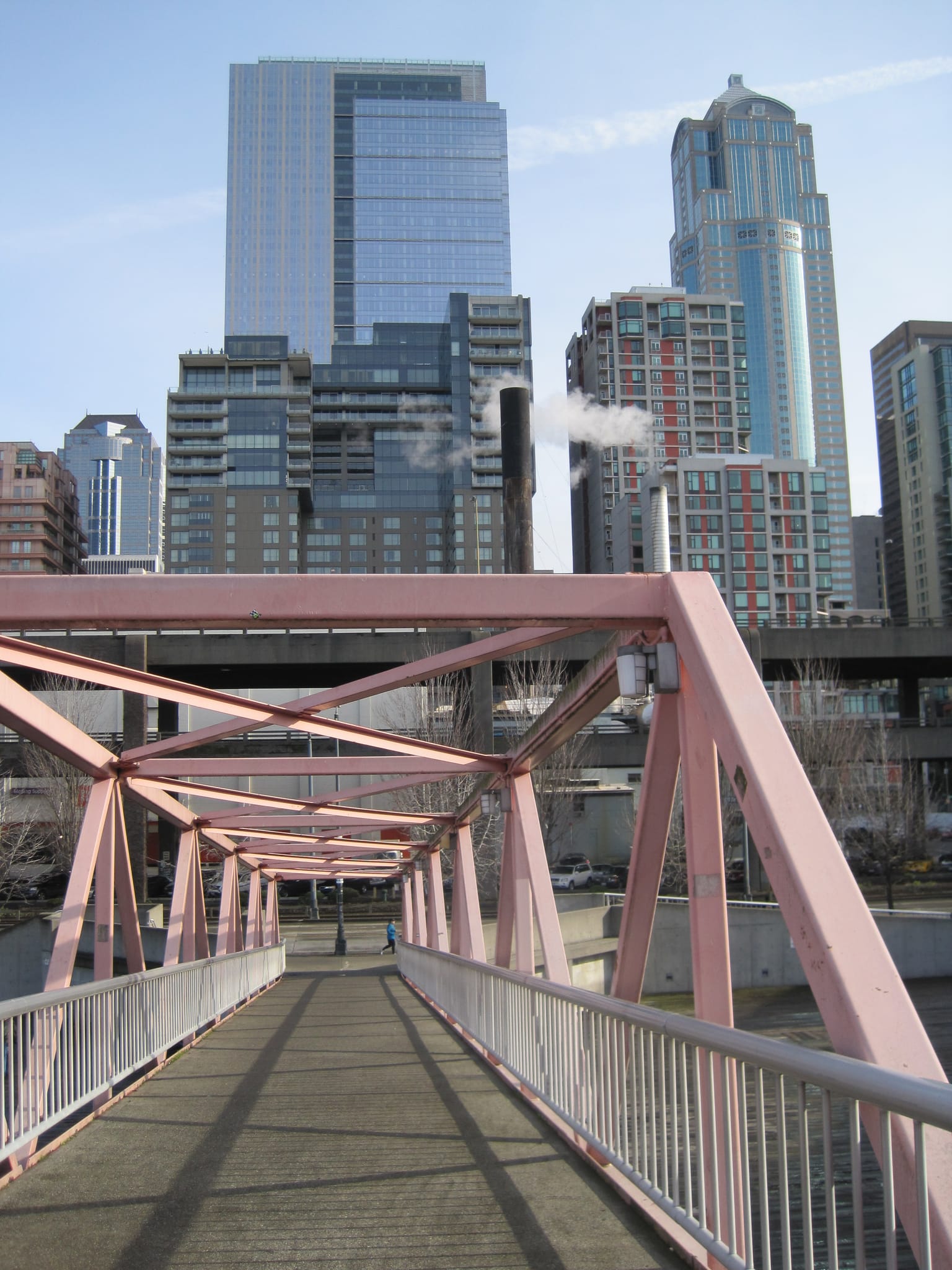 Pedestrian bridge with Seattle skyline.