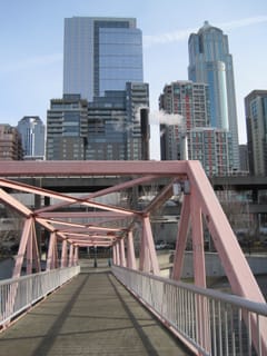 Pedestrian bridge with Seattle skyline.