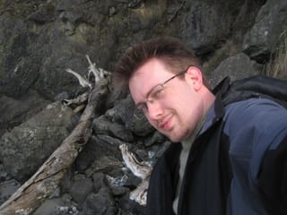 Chris with some logs and rocks on the west beach at Deception Pass