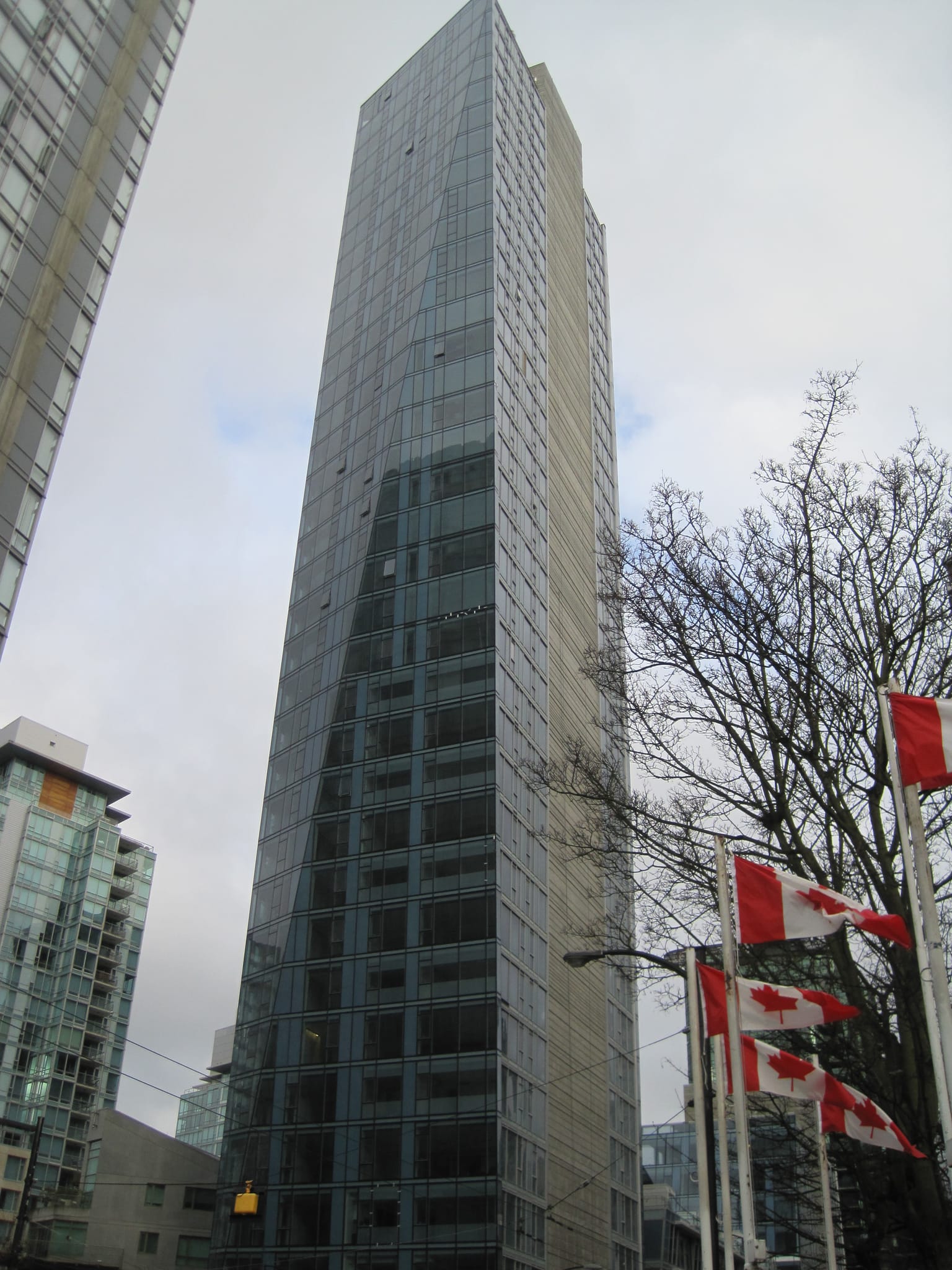 Slant building with flags - Vancouver, BC