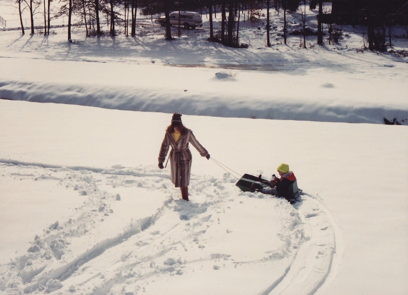 Mom pulls Mr Yellow Boggin' around in the snow