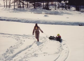 Mom pulls Mr Yellow Boggin' around in the snow