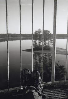 Travelling feet on top of a lighthouse looking out.